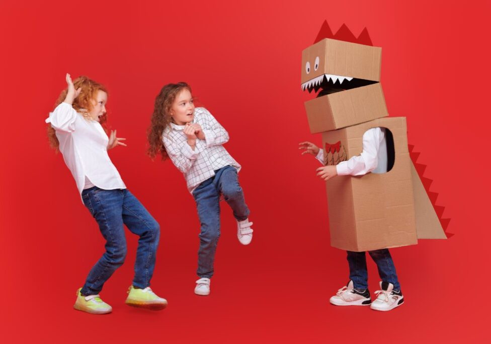 A Child in a Dinosaur Cardboard Box Costume